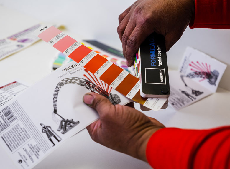 Pantone colour guide being matched against wine label artwork